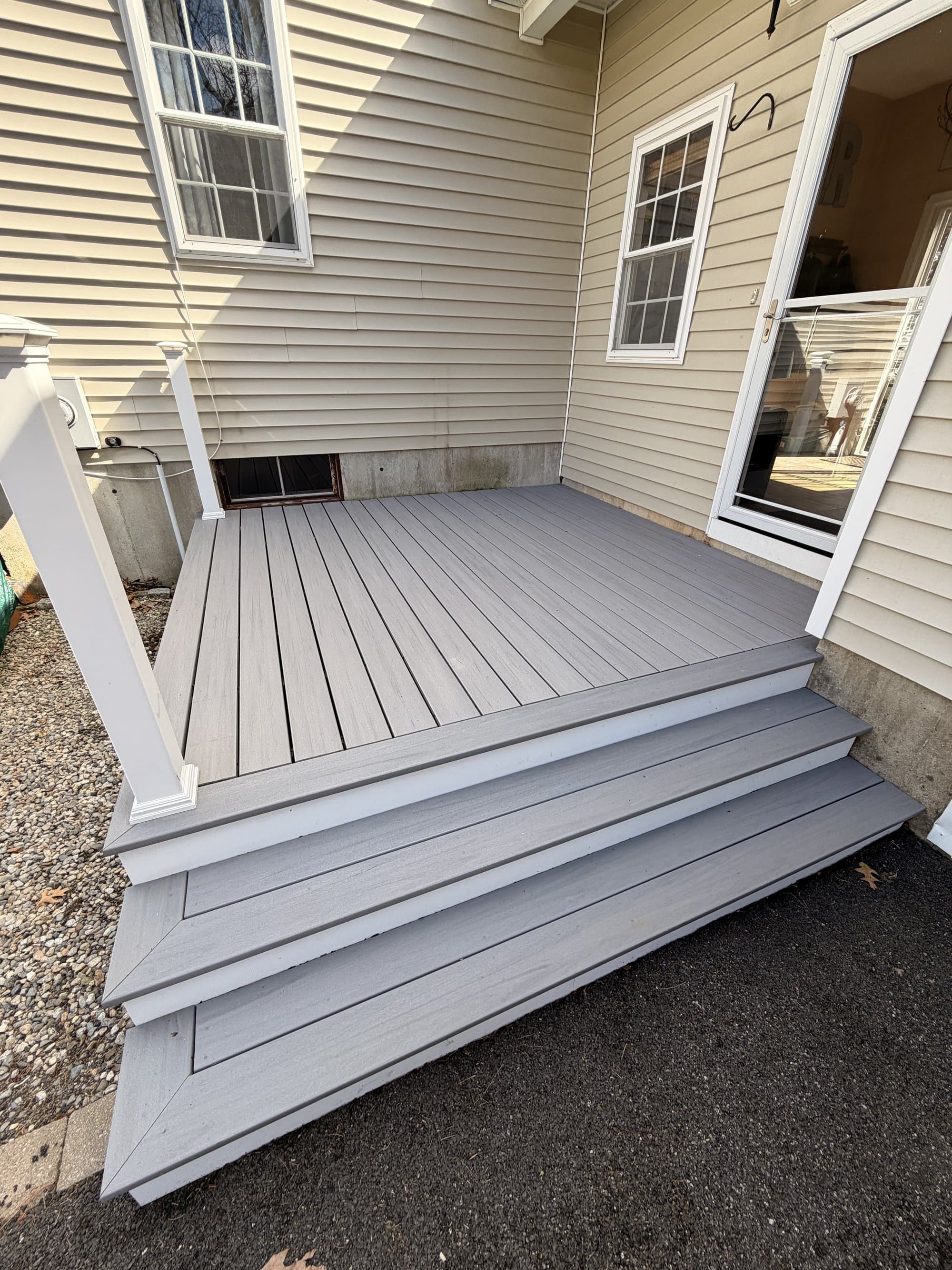 Detail of the wide composite stairs and clean post wrap on the finished side-entry deck