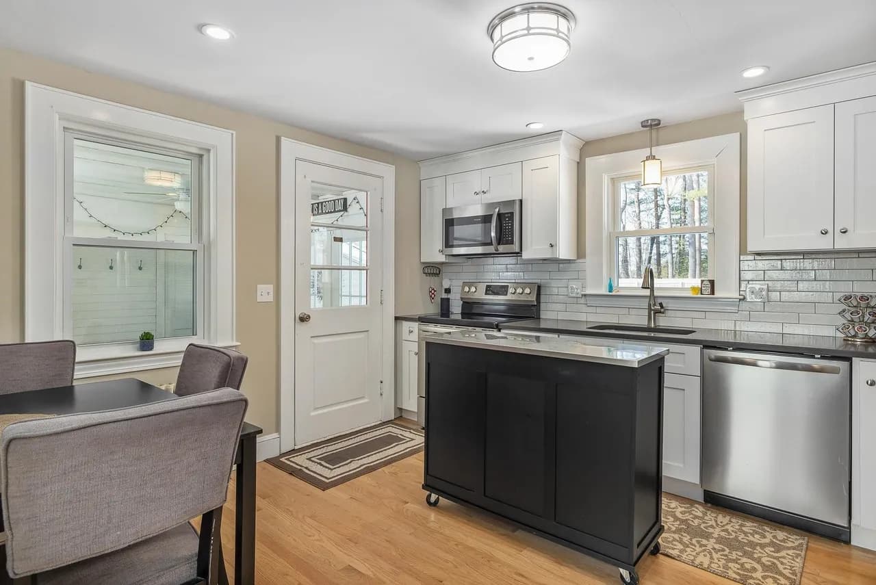Original kitchen before renovation, with an exterior door where the wall was later removed to open up to the new dining space