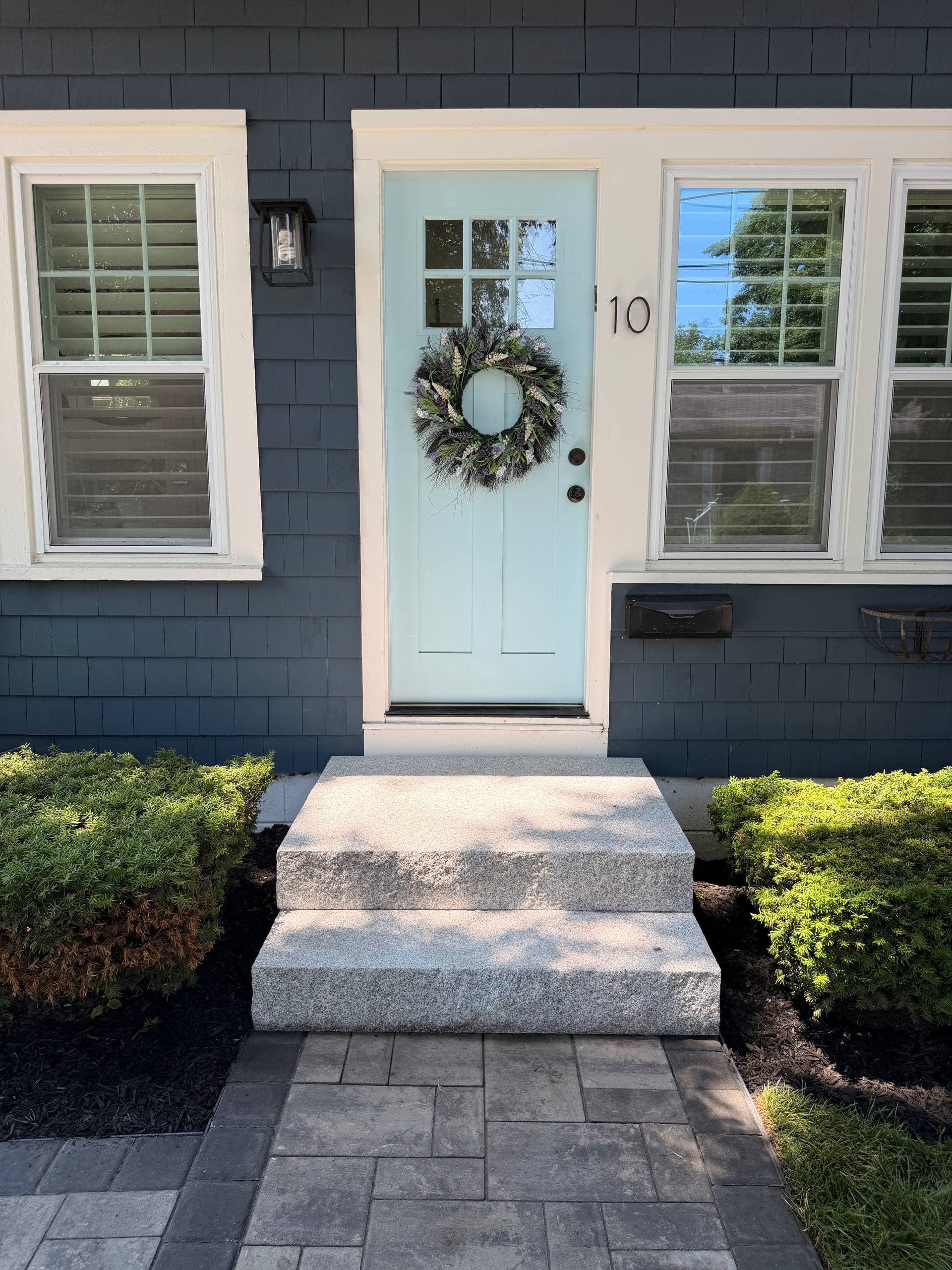 Close-up of the solid granite steps meeting the Ledgestone paver walkway with its darker Coal border