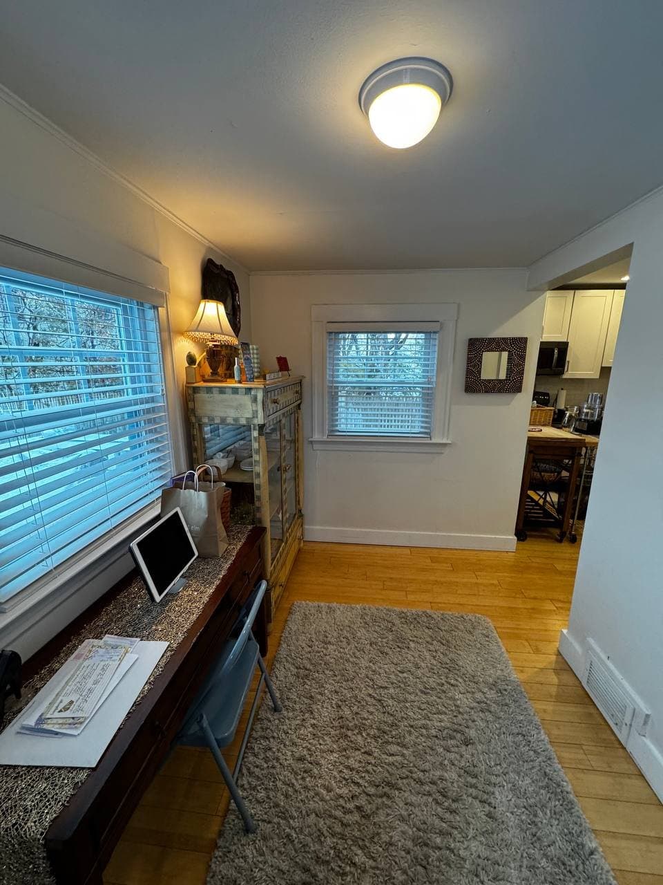 Original mudroom before renovation — opposite wall with an old buffet cabinet and dated trim