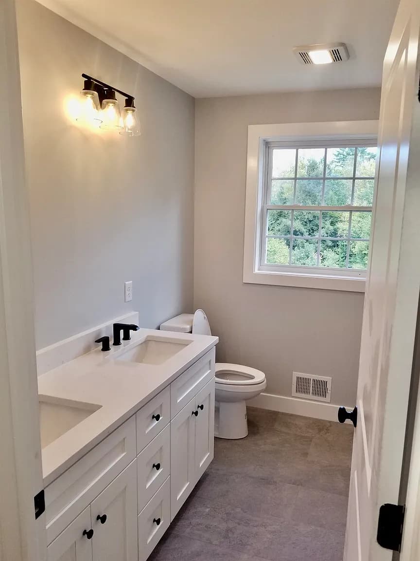 Full bathroom with double vanity and quartz countertop