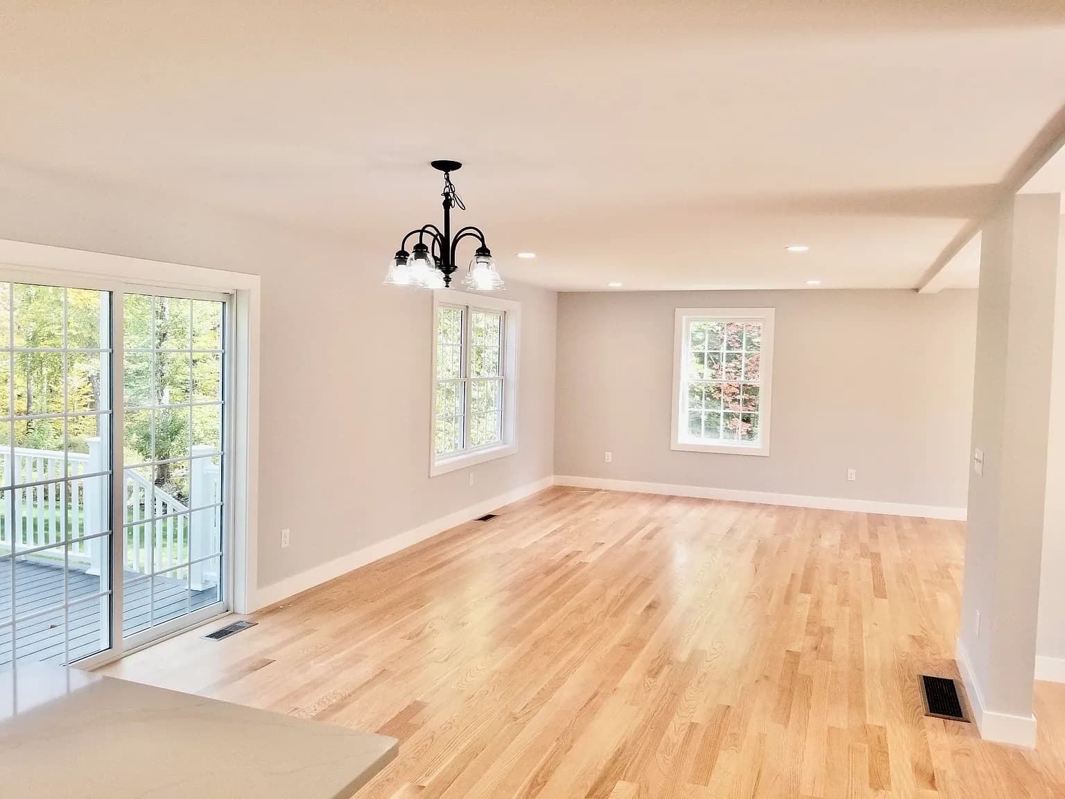 Dining area with chandelier and slider to deck