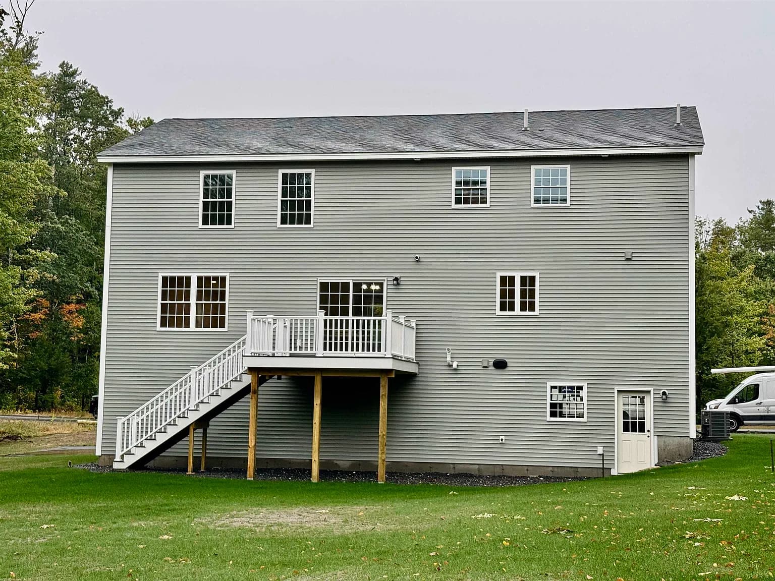 Rear exterior with composite deck and stairs to yard