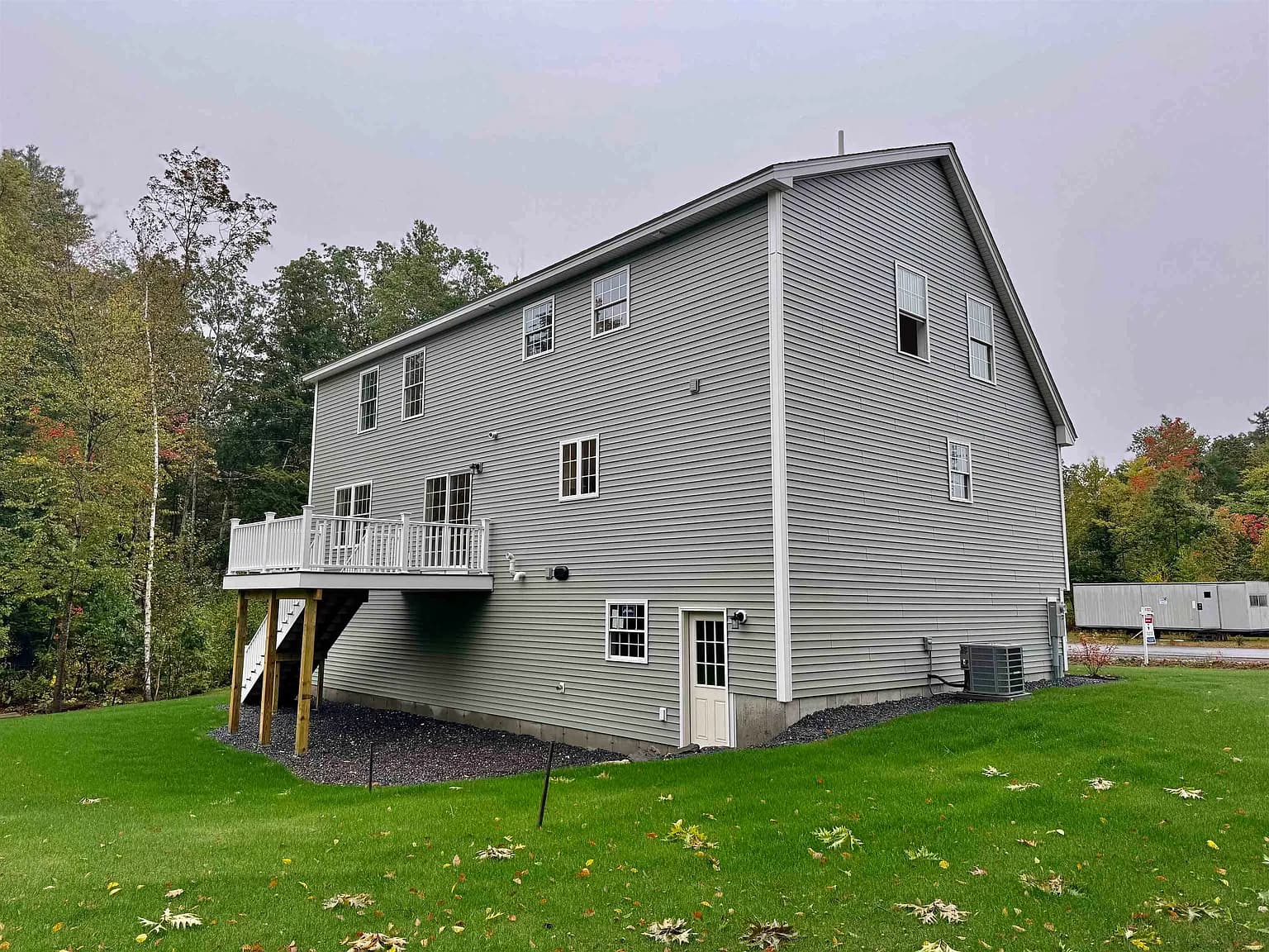 Side view of home showing full height and rear yard