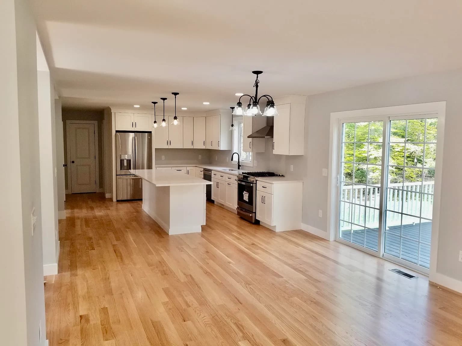 Kitchen open to dining area with slider to rear deck