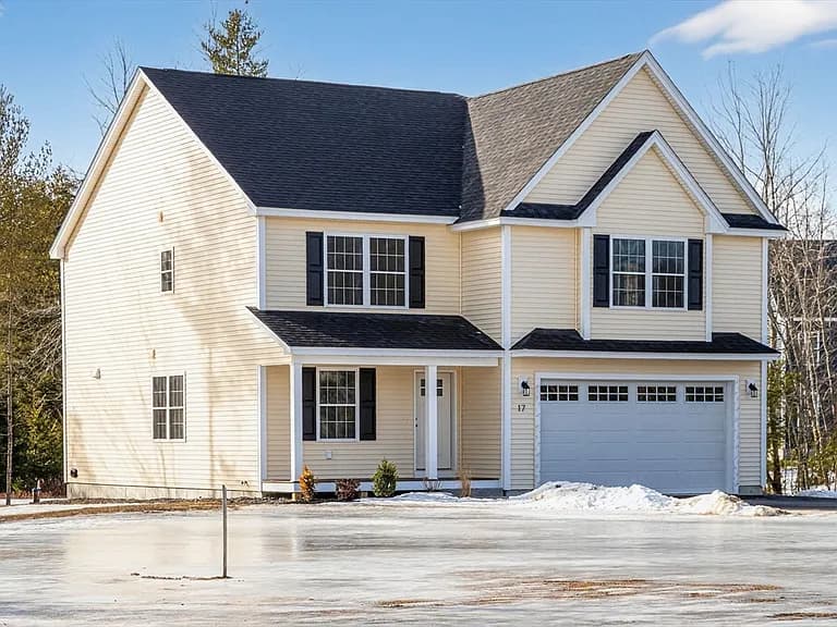 Front exterior of custom colonial with two gables and attached two-car garage